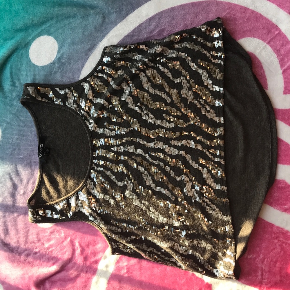 A gray top that has a glitter pattern of stripes.